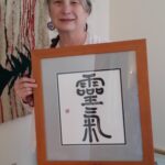 Myra Reichel with Reiki Symbol