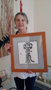 Myra Reichel with Reiki Symbol